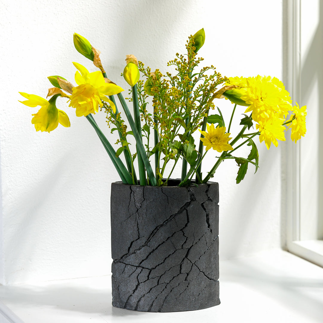 Keramik Vase von Gundula Sommerer, oval, einzigartige Oberfläche durch Rakubrand, Ansicht Front, mit gelben Blumen | haptik.de